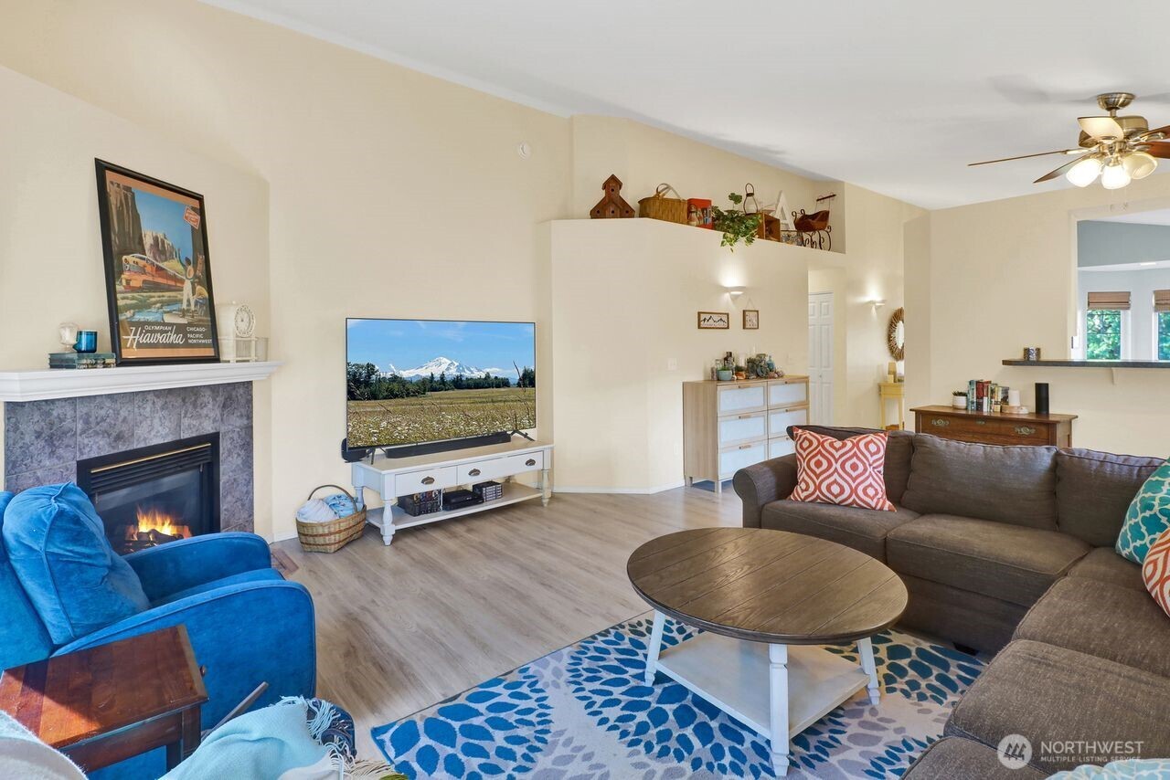 840 Nevada Street Bellingham, WA 98229 - Photo 15 of 38 a living room with furniture a flat screen tv and a fireplace