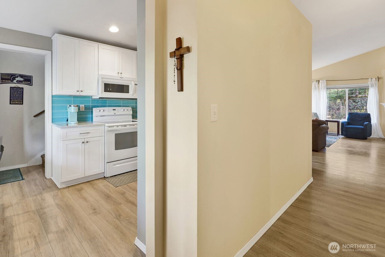 840 Nevada Street Bellingham, WA 98229 - Photo 5 of 38 a kitchen with stainless steel appliances a refrigerator and white cabinets