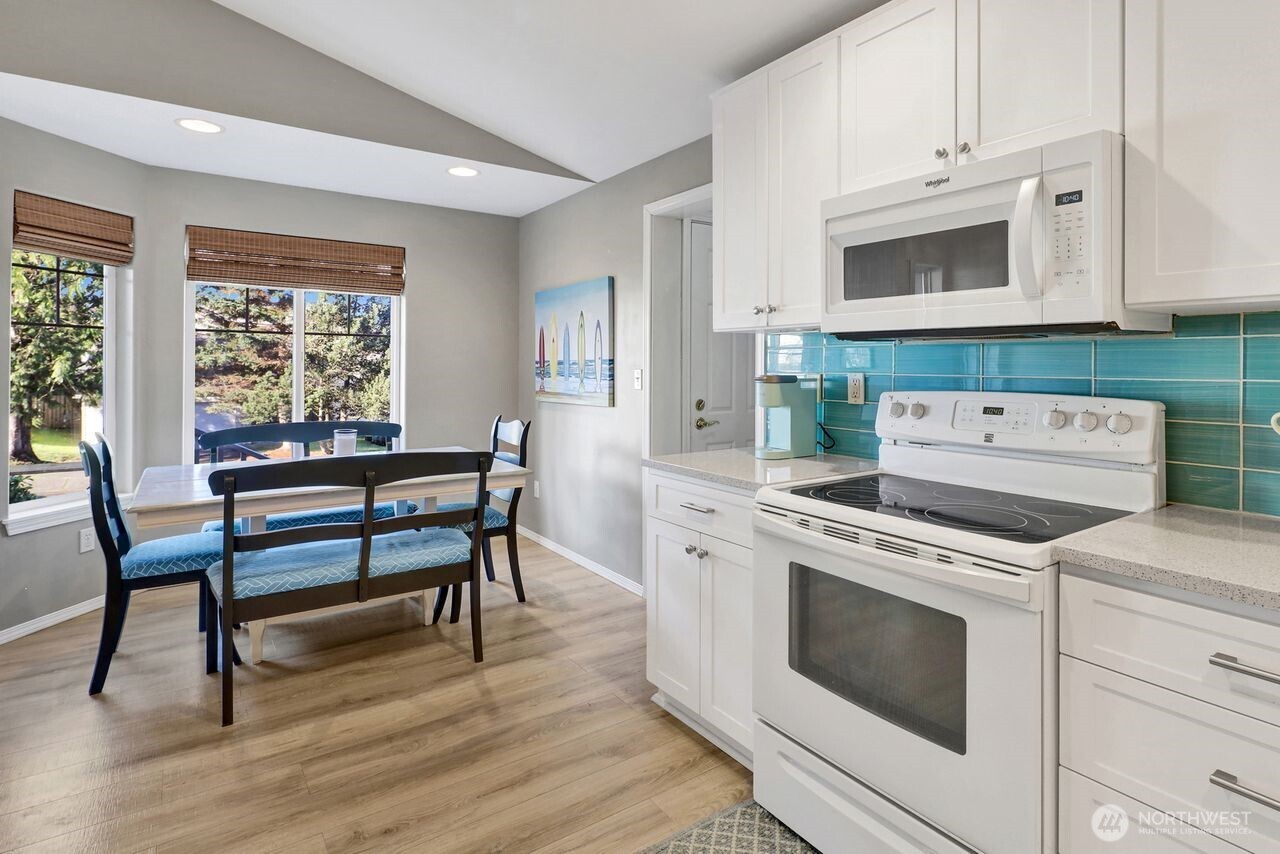 840 Nevada Street Bellingham, WA 98229 - Photo 8 of 38 a kitchen with a stove and a wooden floor