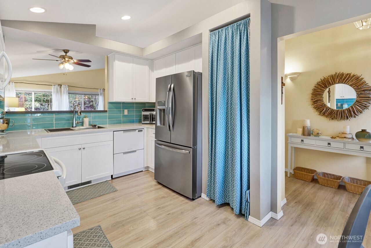 840 Nevada Street Bellingham, WA 98229 - Photo 10 of 38 a kitchen with a refrigerator sink and cabinets