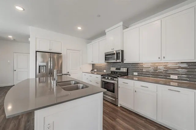 a kitchen with kitchen island a stove and a wooden floors