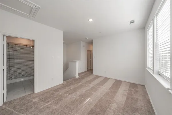 a view of an empty room and a window