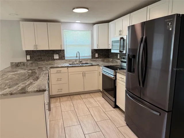 a view of a livingroom with an empty space and a window