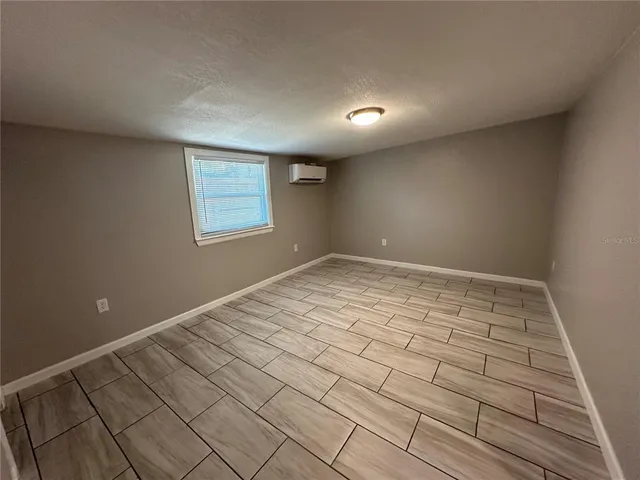 a bathroom with a granite countertop sink a toilet and mirror