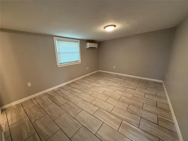 a bathroom with a granite countertop sink a toilet a mirror and shower