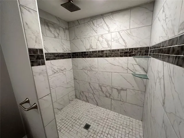 a bathroom with a granite countertop sink a toilet and a bathtub