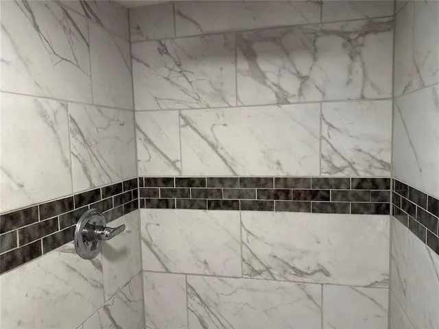 a bathroom with a granite countertop sink a toilet and shower