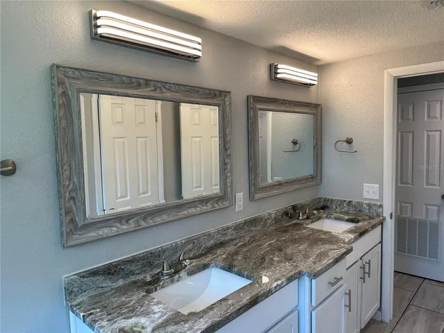 a view of a backyard with wooden fence and trees