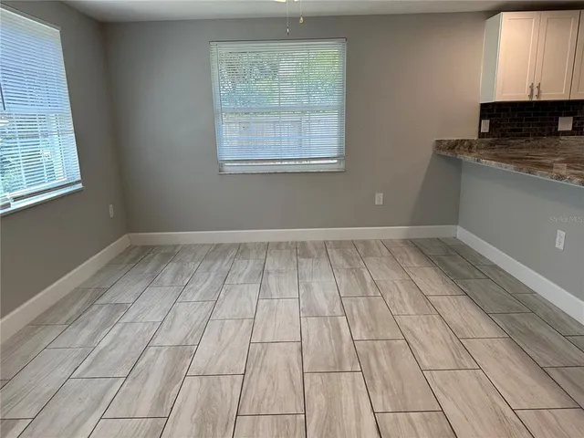 a kitchen with a refrigerator a microwave a sink and a counter top space