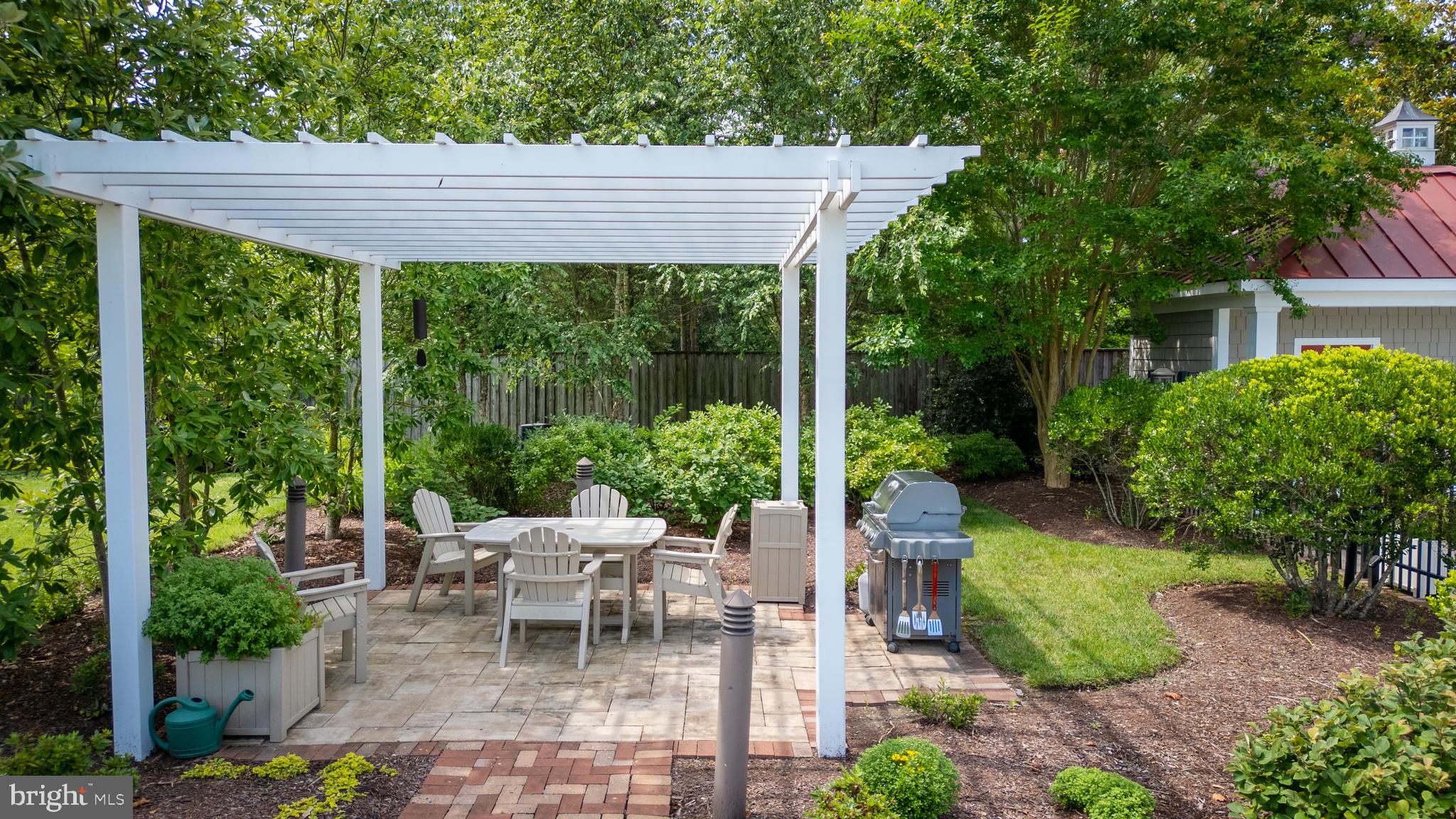106 Landing Lane Chestertown, MD 21620 - Photo 15 of 24 a view of a patio with table and chairs potted plants and large tree