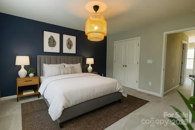 an empty room with a mirror and a chandelier fan