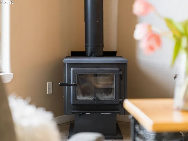 a living room with a fireplace and a potted plant