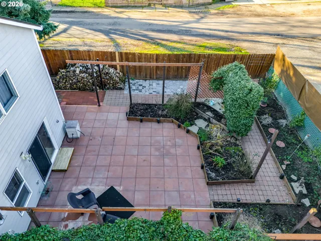 a view of a backyard with plants and a patio