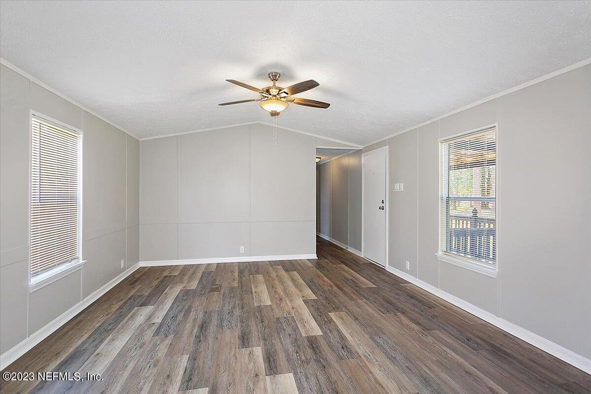 5191 County Road 23B Macclenny, FL 32063 - Photo 2 of 11 wooden floor in an empty room with a window