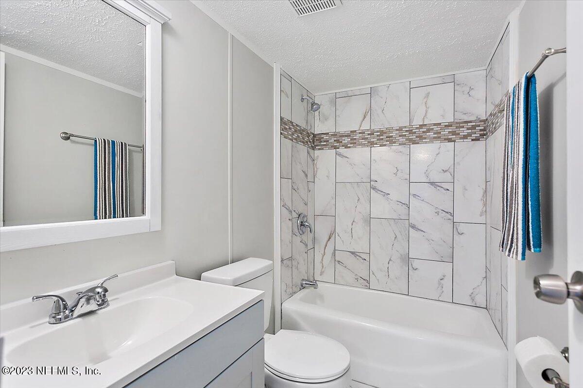 5191 County Road 23B Macclenny, FL 32063 - Photo 8 of 11 a bathroom with a sink toilet and shower