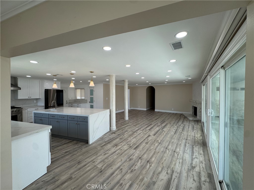 11596 Bart Drive Garden Grove, CA 92841 - Photo 54 of 62 a view of kitchen with kitchen island wooden floor center island and stainless steel appliances