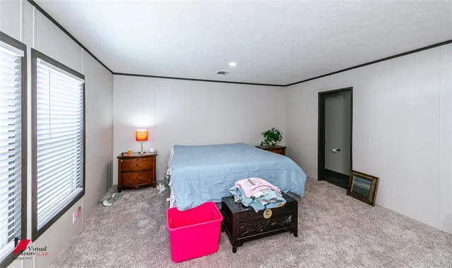 a bedroom with furniture and a window