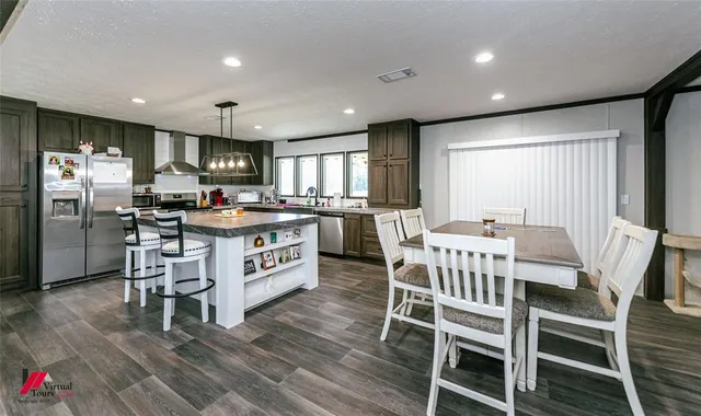 a kitchen with a table chairs refrigerator and window