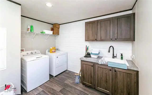 a utility room with sink dryer and washer
