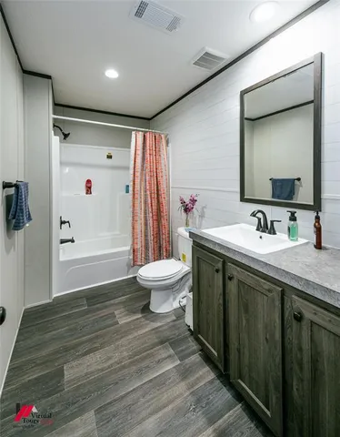 a bathroom with a double vanity sink toilet and shower