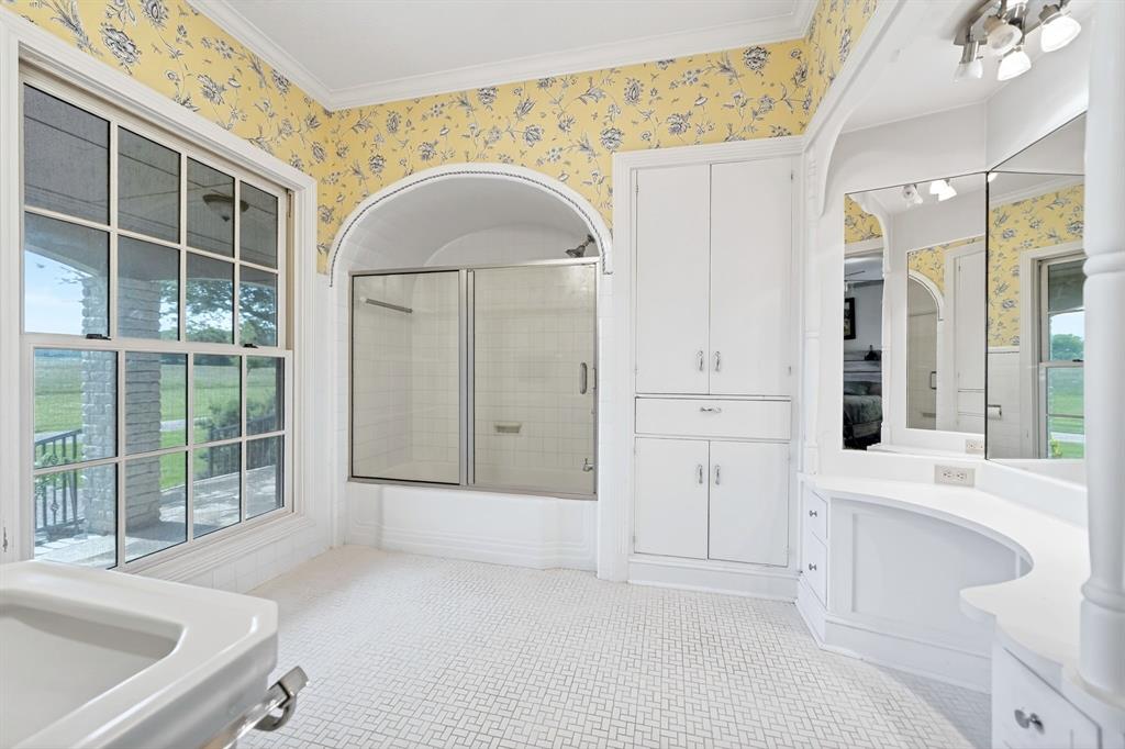 1901 Rose Pointe Athens, TX 75752 - Photo 21 of 37 Bathroom featuring patterned wallpaper and patterned floor tile