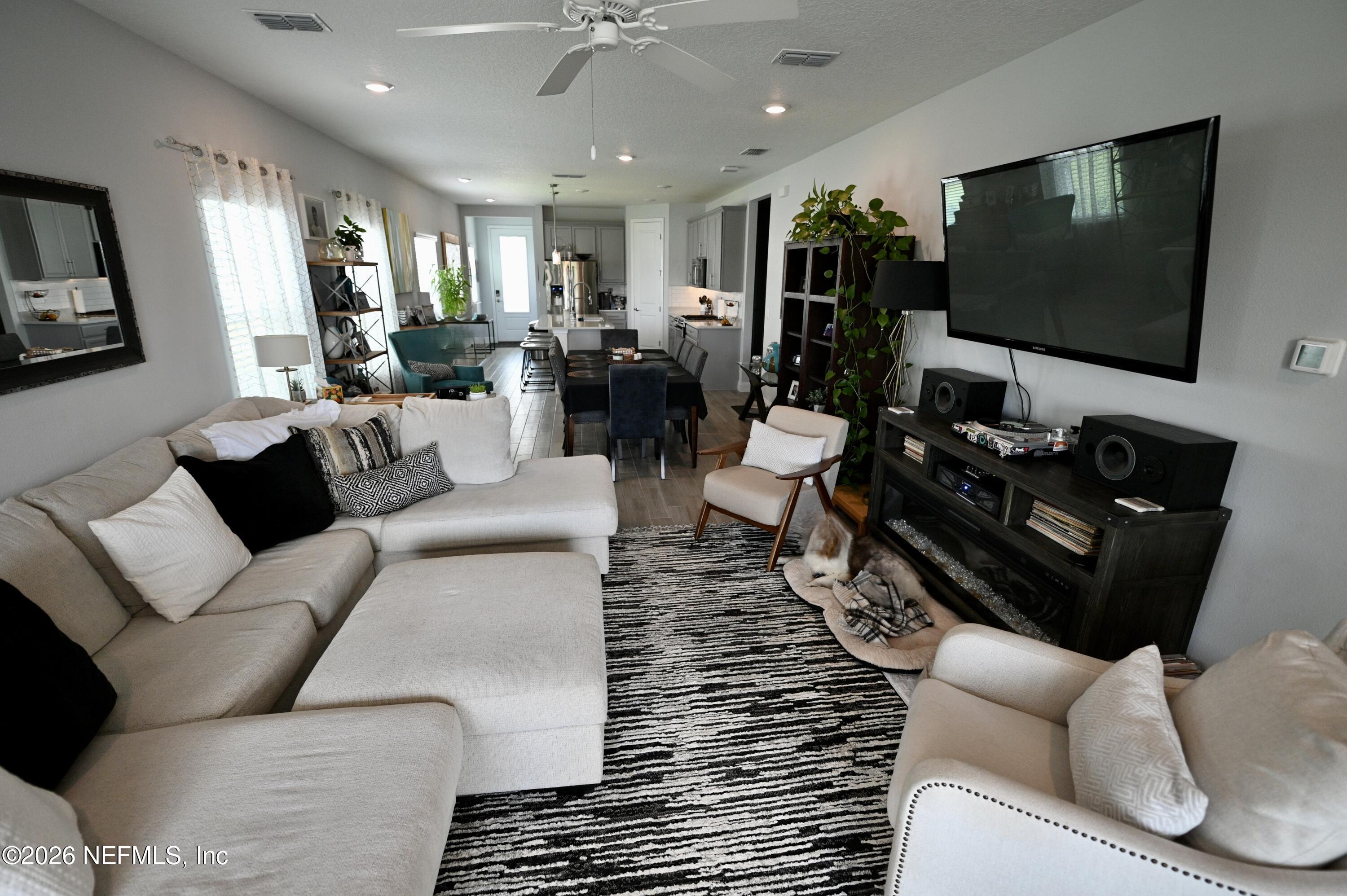 147 Clifton Bay Loop St. Johns, FL 32259 - Photo 23 of 34 a living room with furniture and a flat screen tv