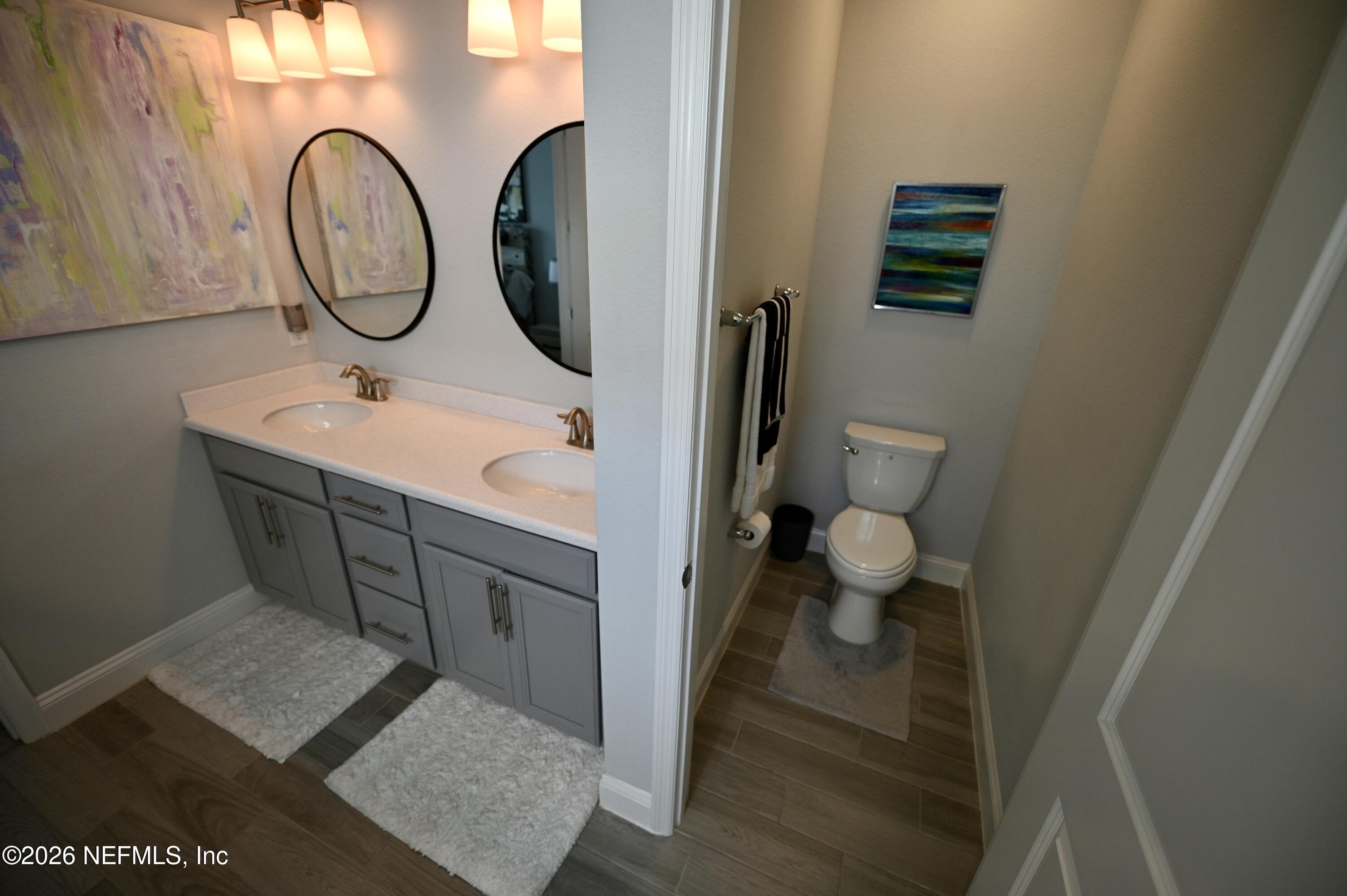 147 Clifton Bay Loop St. Johns, FL 32259 - Photo 31 of 34 a bathroom with a sink and a mirror