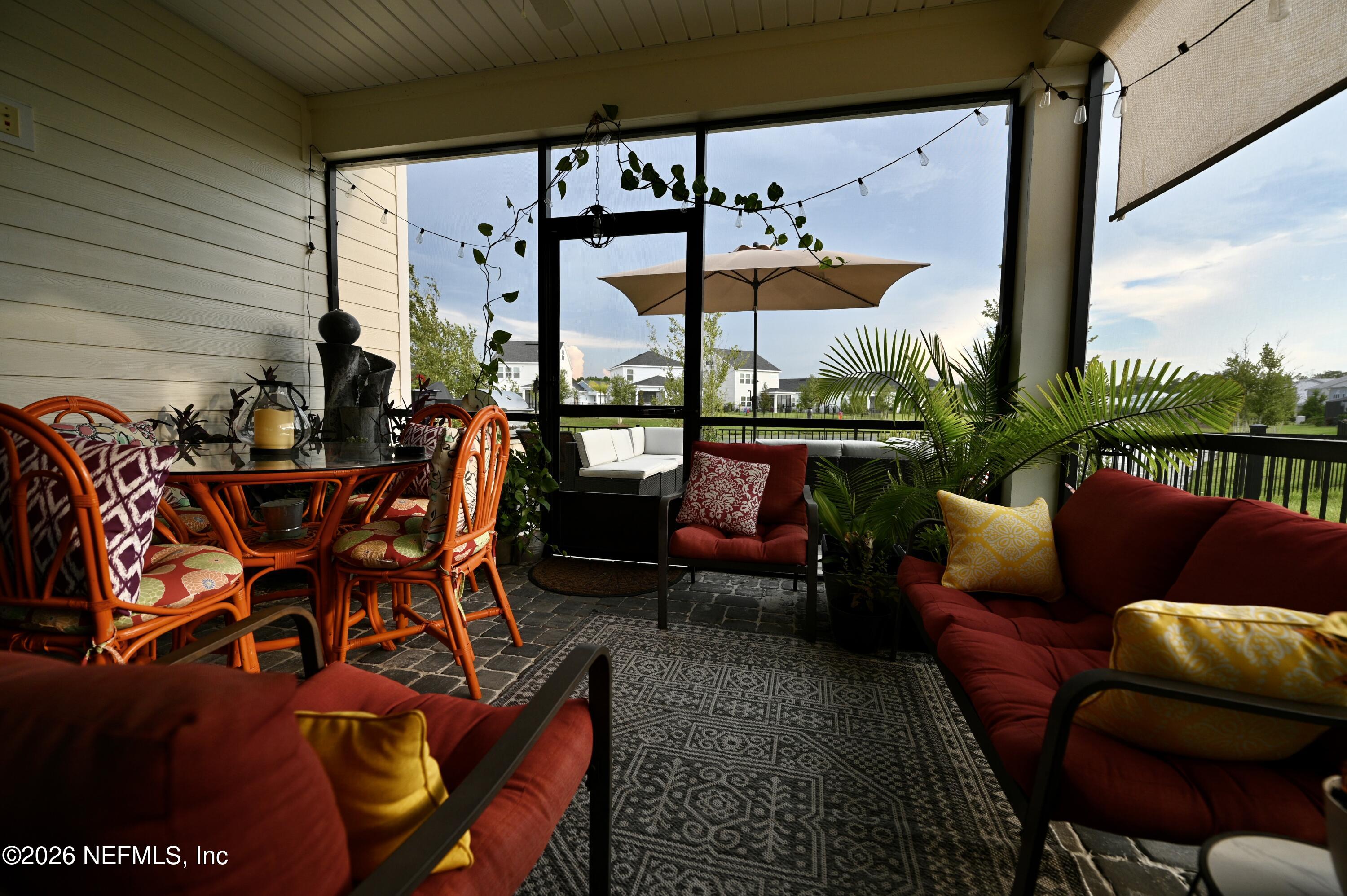 147 Clifton Bay Loop St. Johns, FL 32259 - Photo 8 of 34 an outdoor living area with chairs table and chairs