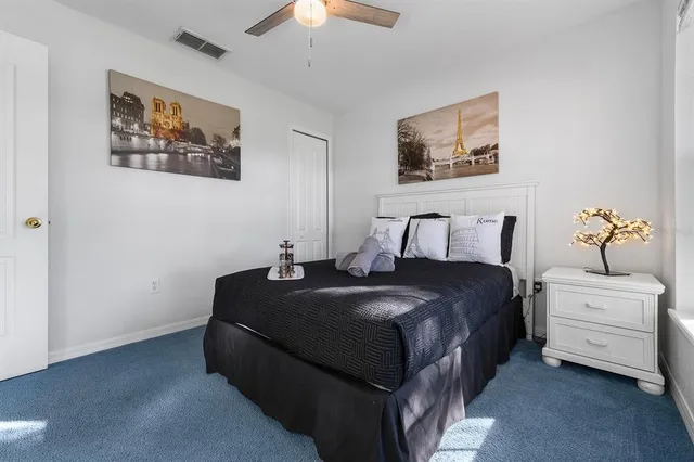 a bedroom with a bed and a painting on the wall