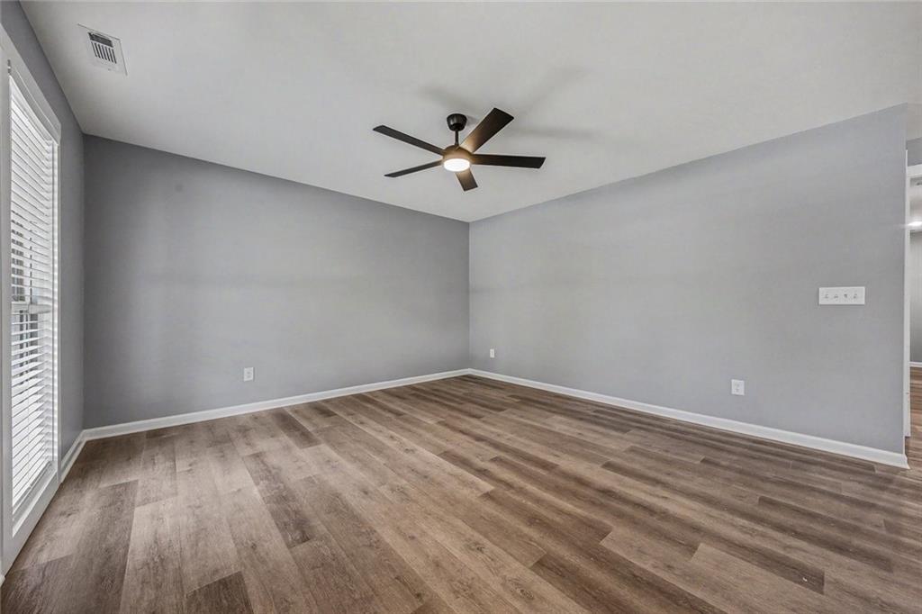 411 Hardy Avenue Southwest Rome, GA 30161 - Photo 4 of 27 wooden floor in an empty room with a window