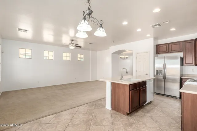 a view of a kitchen with a sink and chandelier