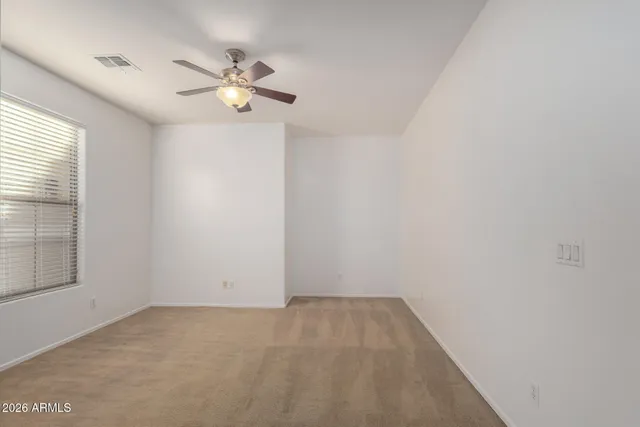 a view of a livingroom with a ceiling fan and window