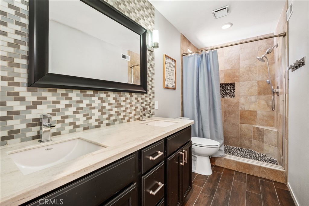 22 Sierra Blanco Lake Forest, CA 92610 - Photo 34 of 47 a bathroom with a sink a toilet a mirror and shower