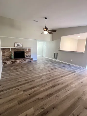 a bathroom with a sink a toilet a mirror and shower