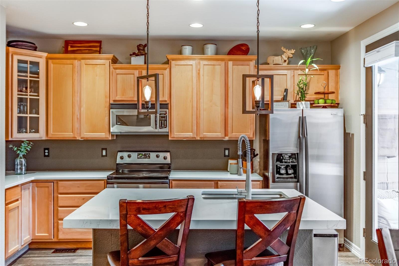 10162 RidgeGate Circle Lone Tree, CO 80124 - Photo 21 of 24 a kitchen with stainless steel appliances granite countertop a refrigerator and a stove top oven