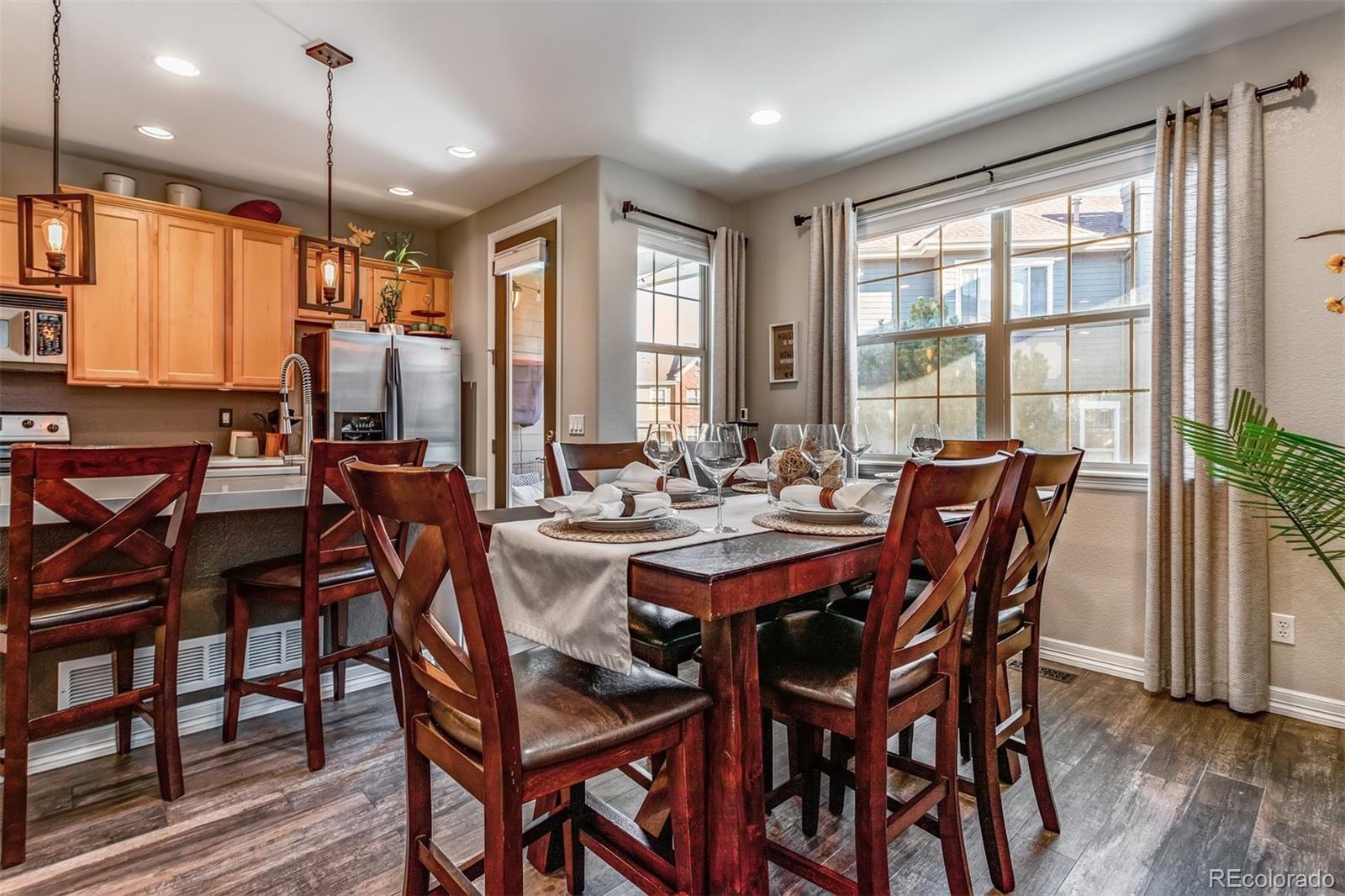 10162 RidgeGate Circle Lone Tree, CO 80124 - Photo 22 of 24 a view of a dining room with furniture window and wooden floor