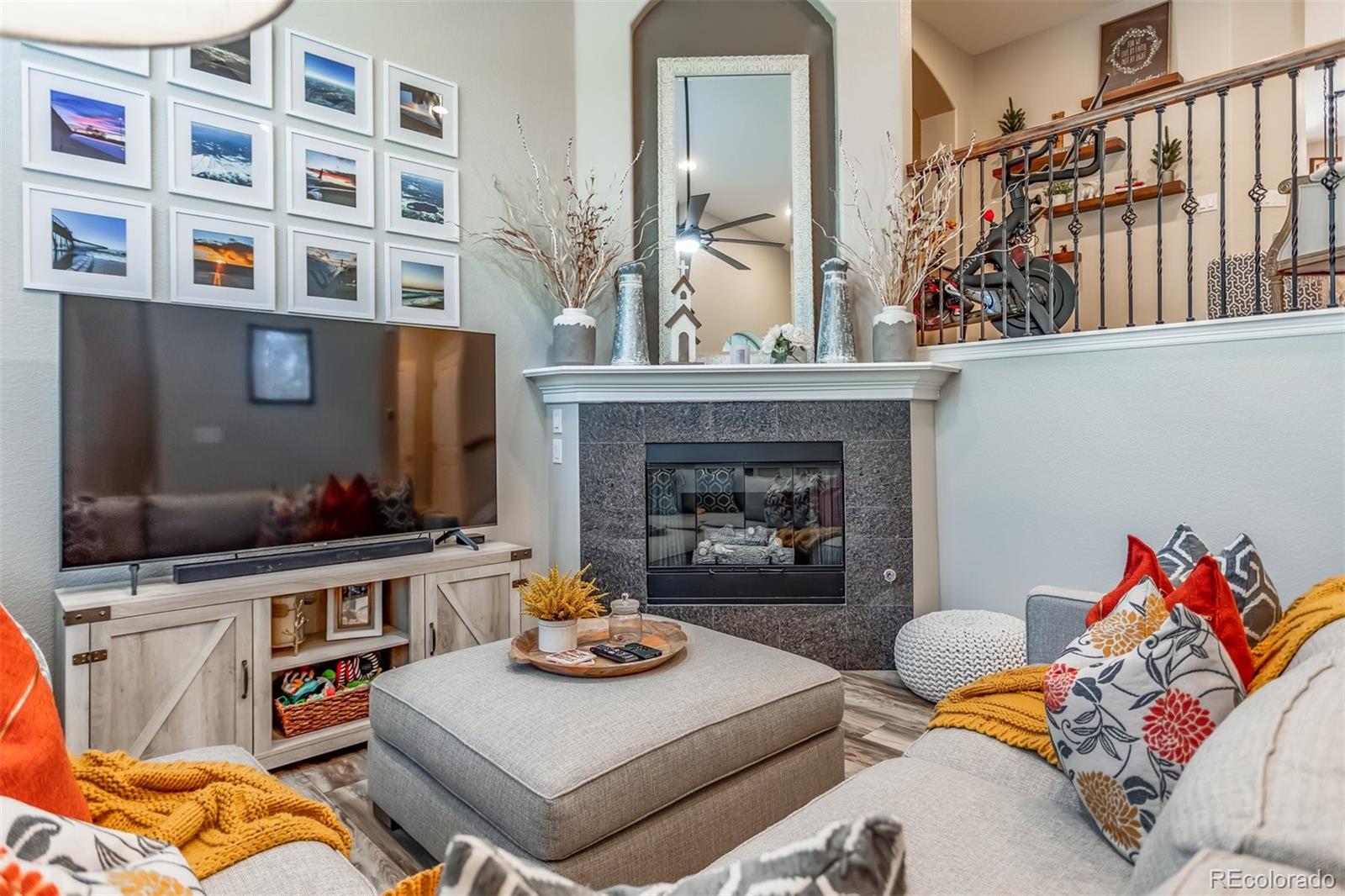 10162 RidgeGate Circle Lone Tree, CO 80124 - Photo 4 of 24 a living room with furniture and a fireplace
