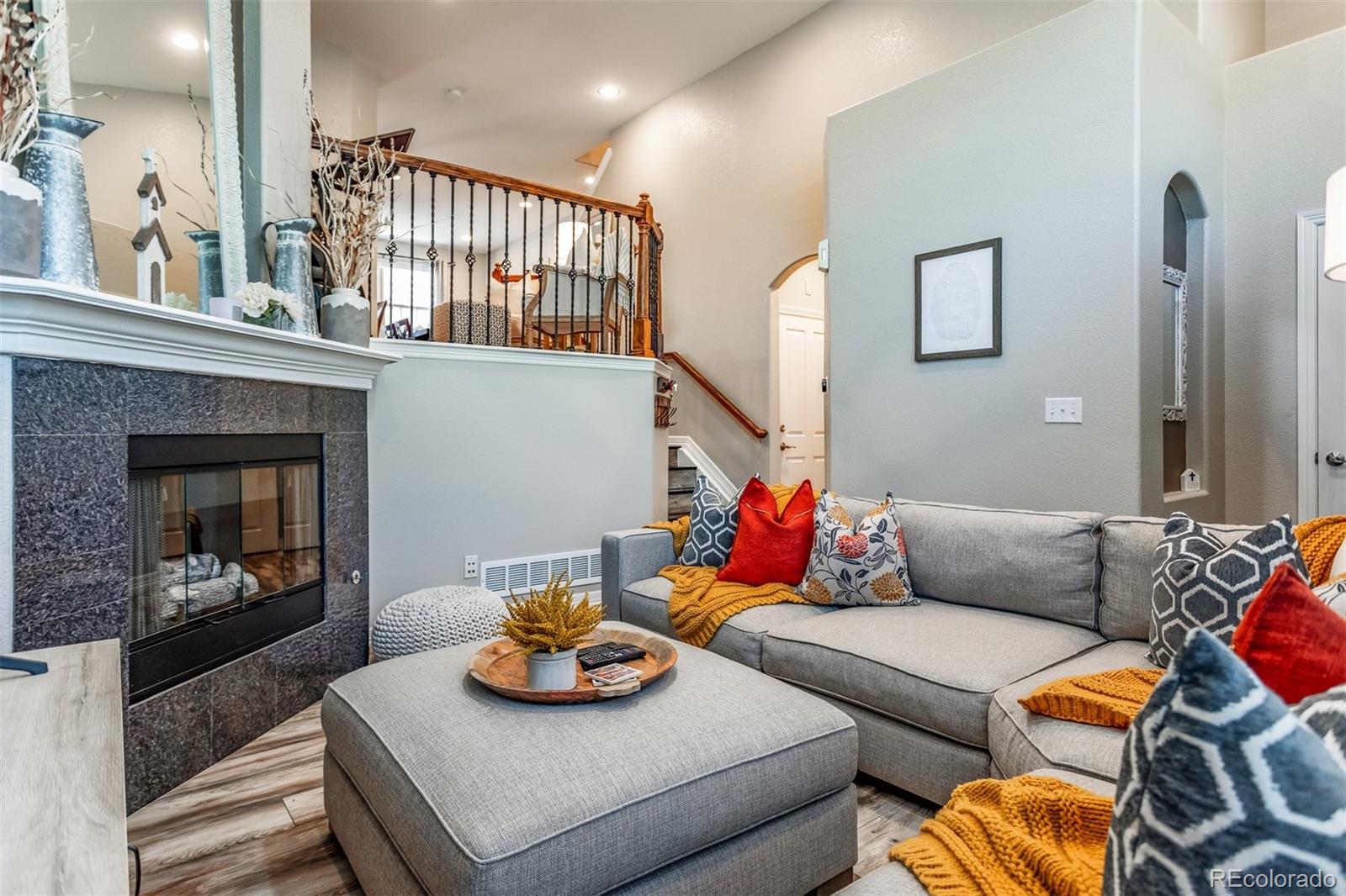 10162 RidgeGate Circle Lone Tree, CO 80124 - Photo 6 of 24 a living room with furniture kitchen view and a fireplace