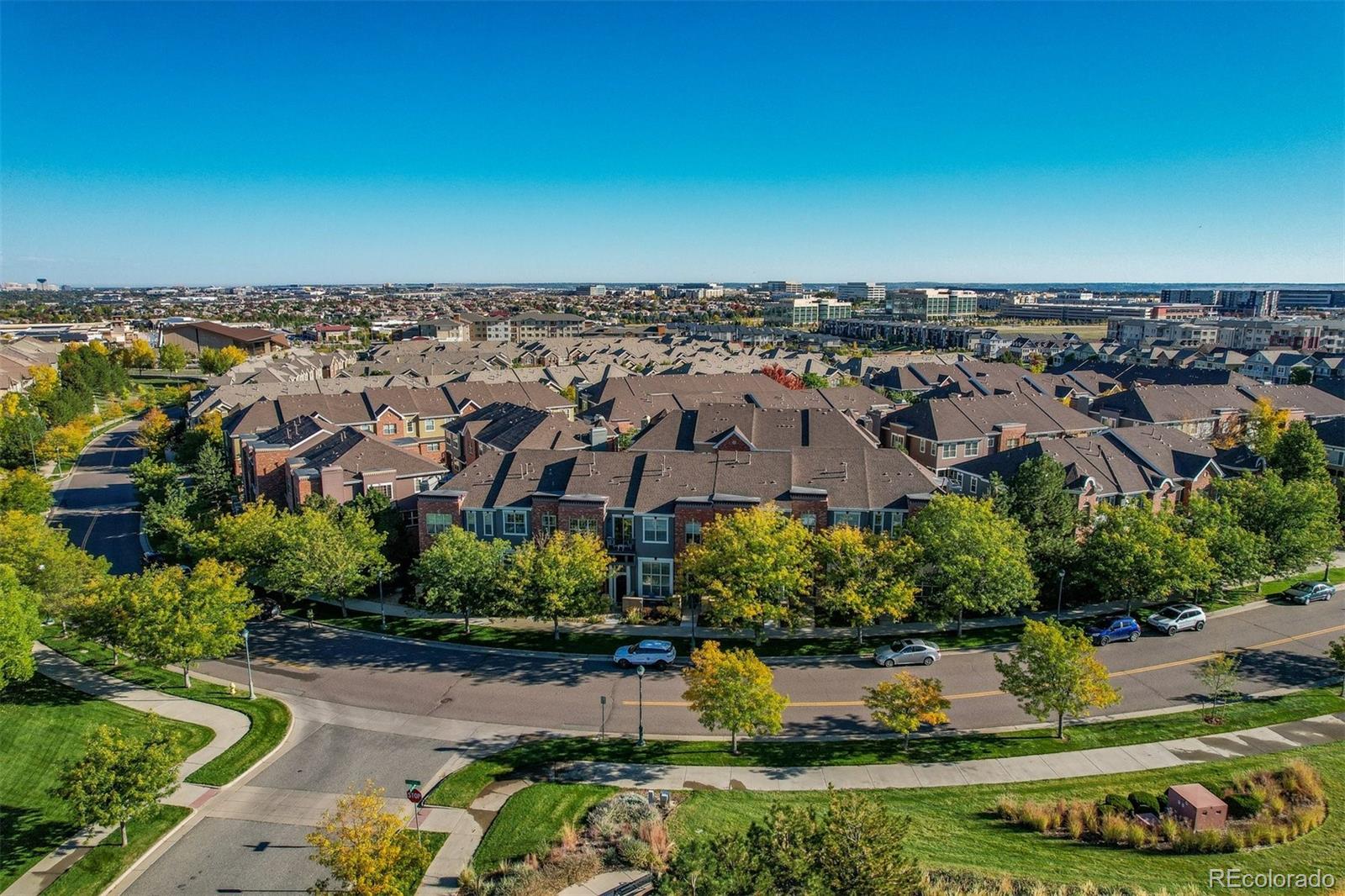 10162 RidgeGate Circle Lone Tree, CO 80124 - Photo 8 of 24 an aerial view of a city with lots of residential buildings ocean and mountain view in back