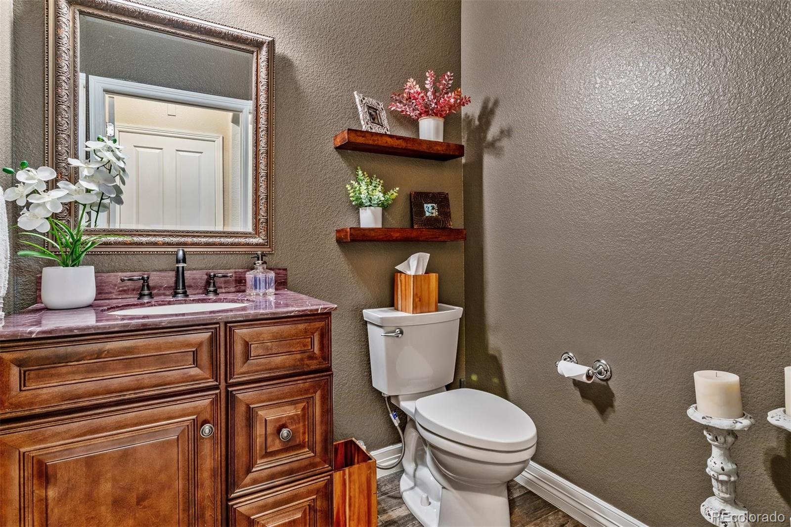 10162 RidgeGate Circle Lone Tree, CO 80124 - Photo 10 of 24 a bathroom with a toilet sink and mirror