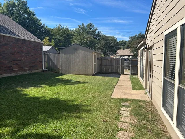 a view of a backyard of the house