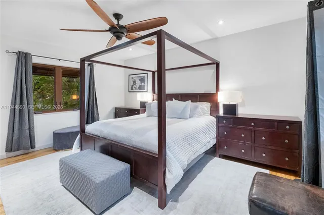 a bedroom with a bed lamp and window