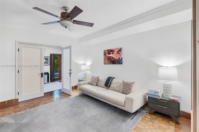 a living room with furniture and a ceiling fan