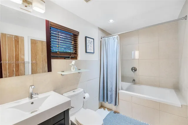 a bathroom with a sink toilet and bathtub
