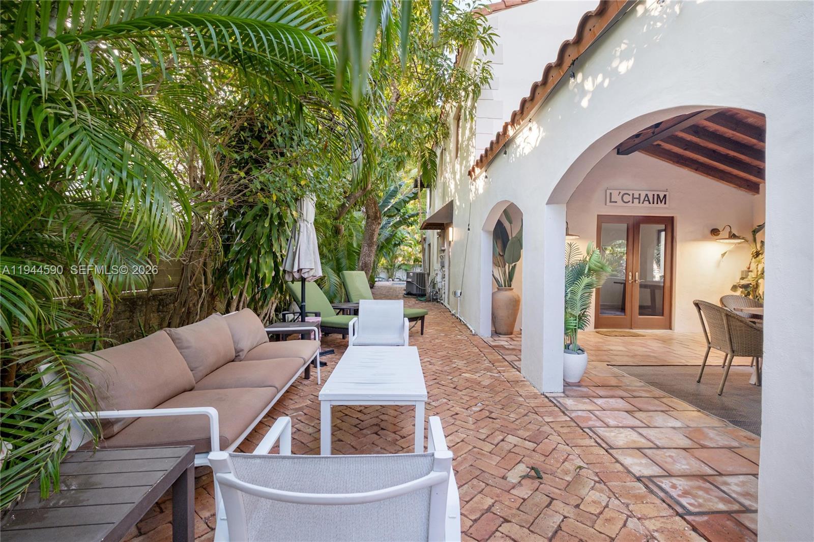320 West 26th Street Miami Beach, FL 33140 - Photo 21 of 33 a view of a patio with couches table and chairs and potted plants