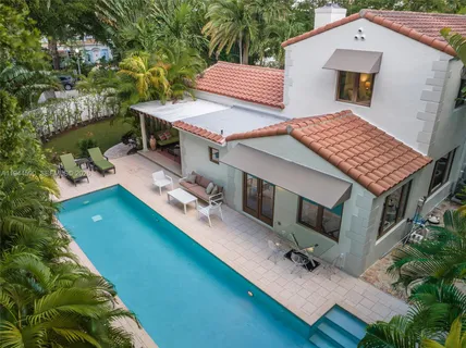 a view of a backyard with sitting area