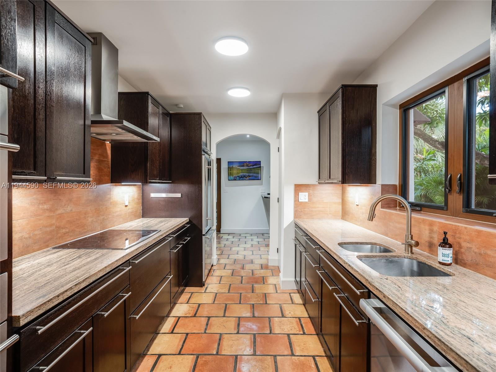 320 West 26th Street Miami Beach, FL 33140 - Photo 10 of 33 a modern kitchen with stainless steel appliances granite countertop a sink stove and refrigerator