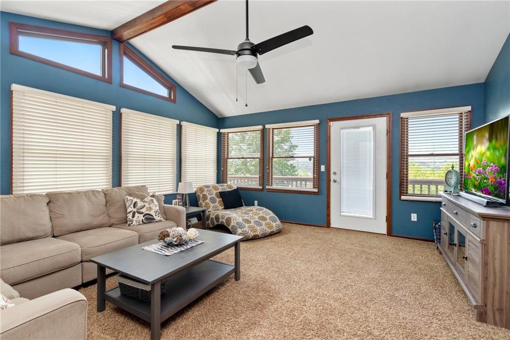101 Unionville Road Freedom, PA 15042 - Photo 12 of 25 Large family room lined with windows, cathedral ceiling and a door to the deck and a door to the parking area.
