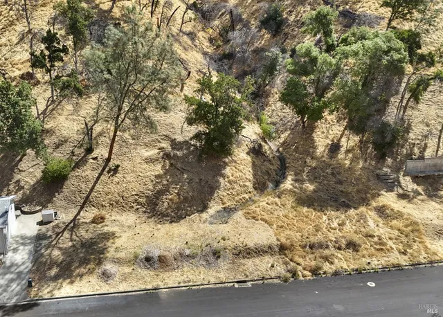 a view of a yard with wooden fence