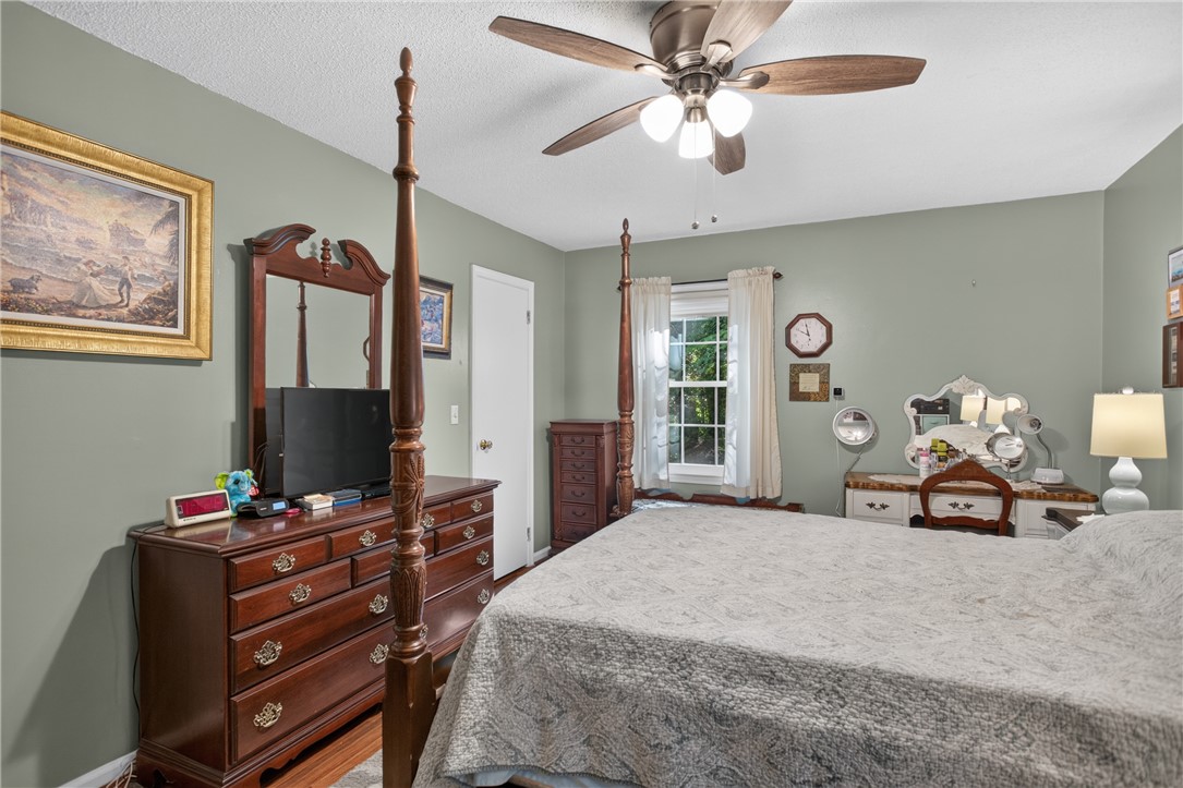 104 Laurel Lane Seneca, SC 29678 - Photo 14 of 36 A comforting bedroom with warm lighting and a tranquil window view, perfect for restful nights.